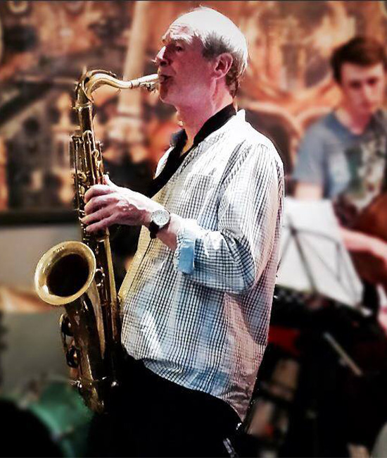 Man in white shirt playing the saxophone